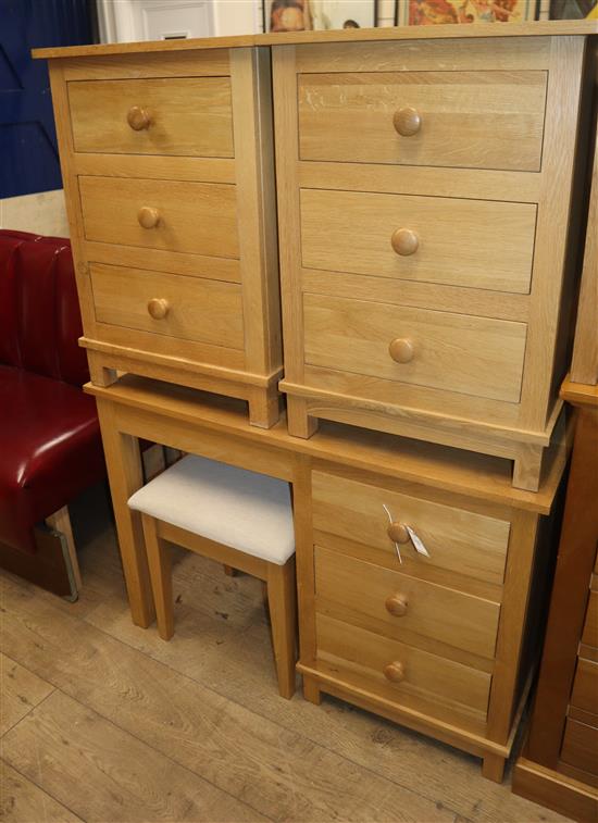 A contemporary oak dressing table, W.106cm, a stool, W.44cm and two bedside chests, W.50cm and 51cm